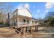 Home back view featuring porch, walkout basement, and landscaped yard at 152 Eastcliff Se Dr, Concord, NC 28025