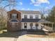 Two story brick home with covered porch and rocking chairs at 152 Eastcliff Se Dr, Concord, NC 28025