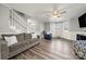 Spacious living room with staircase, ceiling fan, and lots of natural light from the windows at 152 Eastcliff Se Dr, Concord, NC 28025