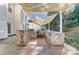 Outdoor kitchen with built-in grill and shade structure at 1983 Trace Creek Dr, Waxhaw, NC 28173