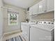 Laundry room with washer, dryer, and cabinets at 2016 Shannon Bridge Ln, Matthews, NC 28105