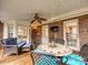 Relaxing screened porch with seating and ceiling fan at 2016 Shannon Bridge Ln, Matthews, NC 28105