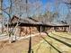 Side view of ranch home showcasing wood siding and stone at 217 Wellington Dr, Matthews, NC 28104