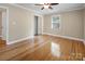 Hardwood floor bedroom with mirrored closet doors and ceiling fan at 2830 Royston Rd, Charlotte, NC 28208