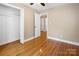 Bedroom with hardwood floors, double-door closet, and access to hallway at 2830 Royston Rd, Charlotte, NC 28208