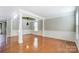 Formal dining room with hardwood floors, wainscoting, and a tray ceiling at 3103 Less Traveled Trl, Indian Trail, NC 28079