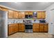 Kitchen features stainless steel appliances and wood cabinets at 3215 Osceola Ln, Charlotte, NC 28269