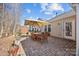 Brick patio with seating area, umbrella, and adjacent shed at 3215 Osceola Ln, Charlotte, NC 28269