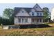 Two-story home under construction featuring a covered porch, black roof, and white window trim at 3215 Player Ct, Salisbury, NC 28144