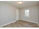 Light-filled bedroom featuring wood-look floors and neutral walls at 3809 Avalon Ave, Charlotte, NC 28208