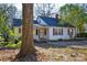 Charming white house with maroon shutters and a large tree in the front yard at 3809 Avalon Ave, Charlotte, NC 28208