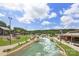 Aerial view of a resort with a lazy river, walking paths, and various amenities at 413 Serenity Cir, Cramerton, NC 28032