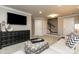 Finished basement with a sectional sofa and neutral decor at 413 Serenity Cir, Cramerton, NC 28032