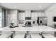 Modern kitchen with white cabinets, quartz countertops, and stainless steel appliances at 413 Serenity Cir, Cramerton, NC 28032