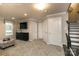 Finished basement with TV, ample storage, and a staircase at 421 Serenity Cir, Cramerton, NC 28032