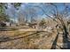 Sloped backyard with shed and mature trees at 4918 Addison Dr, Charlotte, NC 28211