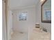 Clean bathroom with single sink vanity, shower, and tiled walls at 4918 Addison Dr, Charlotte, NC 28211