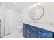 Bathroom with a navy blue vanity, hexagon tile floor and a shower/tub combo at 711 Concord Rd, Davidson, NC 28036
