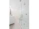 Modern bathroom with a double vanity, glass shower, and marble tile at 711 Concord Rd, Davidson, NC 28036