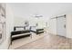 Guest bedroom with two twin beds and a barn door at 711 Concord Rd, Davidson, NC 28036
