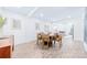 Bright dining room features a round wooden table with seating for six and hardwood floors at 711 Concord Rd, Davidson, NC 28036