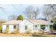 Charming single-story home with light blue door, covered porch, and beautiful landscaping at 711 Concord Rd, Davidson, NC 28036