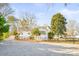 White house exterior with gravel driveway and trees at 711 Concord Rd, Davidson, NC 28036