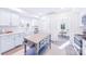 Modern kitchen with white cabinets, an island, and stainless steel appliances at 711 Concord Rd, Davidson, NC 28036