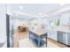 Modern kitchen with white cabinets, a kitchen island, and stainless steel appliances at 711 Concord Rd, Davidson, NC 28036