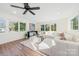 Sunlit living room boasts a large sectional sofa and ample natural light at 711 Concord Rd, Davidson, NC 28036