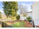 Landscaped side yard with a white house and black fence at 711 Concord Rd, Davidson, NC 28036