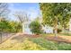 Landscaped side yard with a white house and black fence at 711 Concord Rd, Davidson, NC 28036