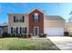 Two-story house with brick and beige siding, a two-car garage, and well-manicured lawn at 7225 Sandown Ct, Harrisburg, NC 28075