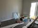 A bedroom with exposed floorboards and construction debris at 9101 Spyglass Pl # A, Charlotte, NC 28214