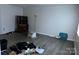 A cluttered living room with gray walls and wood-look flooring at 9101 Spyglass Pl # A, Charlotte, NC 28214