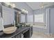 Elegant bathroom with double sinks, soaking tub, and separate shower at 10102 Grimsby Ct, Huntersville, NC 28078