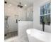 Modern bathroom featuring a glass-enclosed shower and a separate soaking tub with natural lighting at 108 Robinson Dr, Cherryville, NC 28021