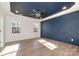 Elegant bedroom with a decorative blue accent wall, wood floors, natural light, and recessed lighting at 108 Robinson Dr, Cherryville, NC 28021