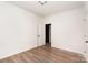 This bedroom has wood-look flooring, neutral paint, and a door to another room at 108 Robinson Dr, Cherryville, NC 28021