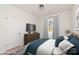 Cozy bedroom with a queen bed, dresser with television, window, and neutral color scheme at 108 Robinson Dr, Cherryville, NC 28021