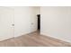 Bedroom with wood-look floors, neutral paint, and an open door to another room at 108 Robinson Dr, Cherryville, NC 28021
