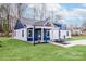 Beautiful home featuring eye-catching blue accents, a covered porch, and manicured landscaping at 108 Robinson Dr, Cherryville, NC 28021