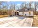 This is a charming home with a symmetrical front facade, a large concrete driveway, and manicured landscaping at 108 Robinson Dr, Cherryville, NC 28021