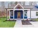 Inviting front entrance of this home, showcasing a striking blue facade, and a covered porch at 108 Robinson Dr, Cherryville, NC 28021