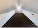 Large attic room with floral wallpaper and carpeted floor at 117 Mardon Ln, Statesville, NC 28677