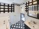 Bathroom with walk-in shower, jetted tub, and stylish black and white flooring at 117 Mardon Ln, Statesville, NC 28677