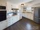 Open kitchen features white cabinets and gas range at 117 Mardon Ln, Statesville, NC 28677