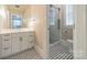 Bathroom with a white vanity, patterned floors, and glass shower door at 1333 Carlton Ave, Charlotte, NC 28203