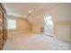 Large bedroom with built-in storage, neutral carpet and skylights at 1333 Carlton Ave, Charlotte, NC 28203
