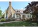 Charming home exterior with stone chimney and foundation, beautiful lawn and landscaping at 1333 Carlton Ave, Charlotte, NC 28203